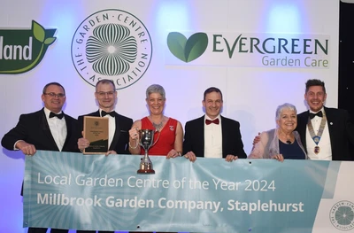 Millbrook team collecting trophy for winning Local Garden Centre of the Year